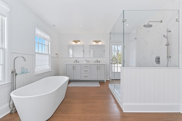 Bathroom, Dual Sink Vanities, Free Standing Baths, Glass Shower, Interior, Marble Walls, Recessed Lighting, Wood Texture Flooring