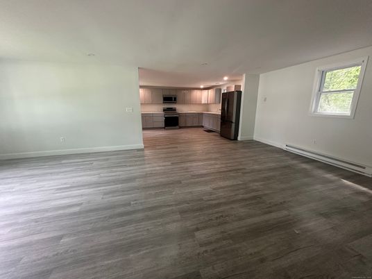 Empty room, Interior, Kitchen, Recessed Lighting, Stainless Steel Appliances, Wood Texture Flooring