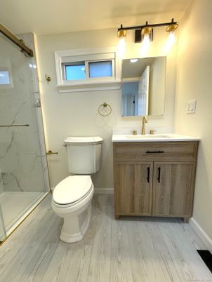 Bathroom, Glass Shower, Interior, Marble Walls, Wood Texture Flooring