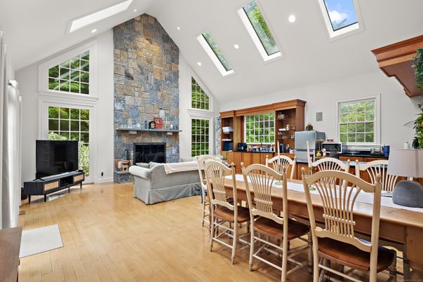 Dining room, Fireplace, Interior, Living room, Recessed Lighting, Stone Walls, Wood Texture Flooring