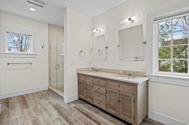 Bathroom, Dual Sink Vanities, Glass Shower, Interior, Recessed Lighting, Wood Texture Flooring