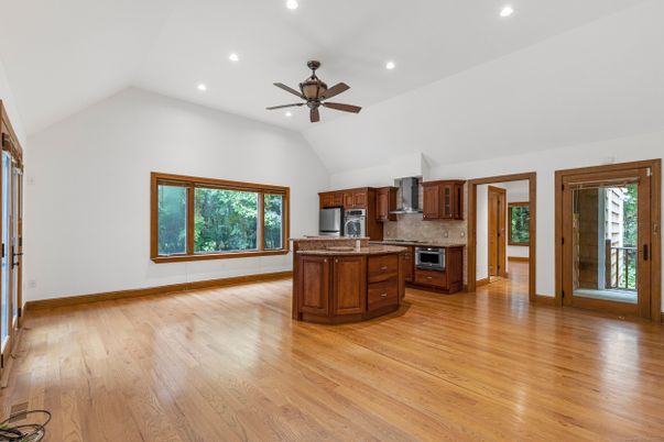 Empty room, Interior, Kitchen, Recessed Lighting, Stainless Steel Appliances, Wood Texture Flooring