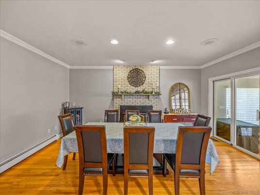 Dining room, Fireplace, Interior, Recessed Lighting, Stone Walls, Wood Texture Flooring