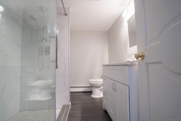 Bathroom, Glass Shower, Interior, Marble Walls, Wood Texture Flooring
