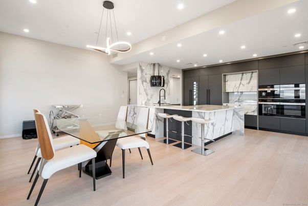 Dining room, Interior, Kitchen, Marble Walls, Pendant Lights, Recessed Lighting, Stainless Steel Appliances, Wood Texture Flooring