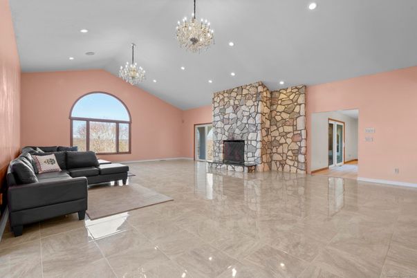 Chandelier, Empty room, Fireplace, Interior, Living room, Recessed Lighting, Stone Walls
