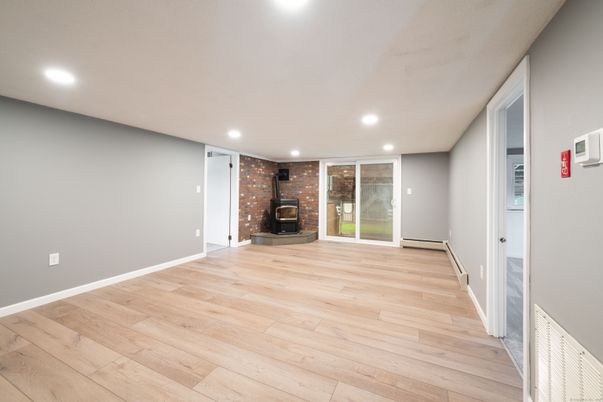 Empty room, Fireplace, Interior, Recessed Lighting, Stone Walls, Wood Texture Flooring