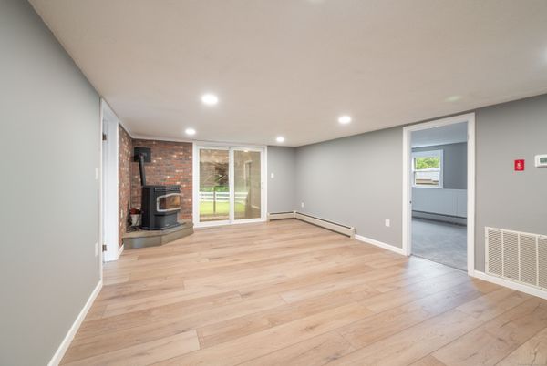 Empty room, Fireplace, Interior, Recessed Lighting, Stone Walls, Wood Texture Flooring