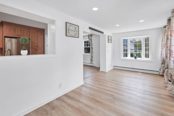 Empty room, Interior, Kitchen, Recessed Lighting, Stainless Steel Appliances, Wood Texture Flooring