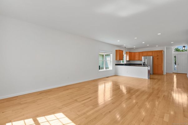 Empty room, Interior, Kitchen, Recessed Lighting, Stainless Steel Appliances, Wood Texture Flooring