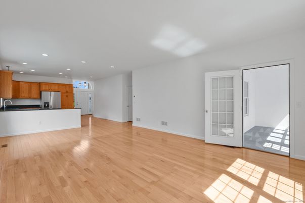 Empty room, Interior, Kitchen, Recessed Lighting, Stainless Steel Appliances, Wood Texture Flooring