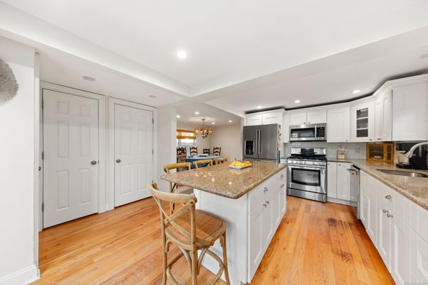Chandelier, Dining room, Interior, Kitchen, Recessed Lighting, Stainless Steel Appliances, Wood Texture Flooring