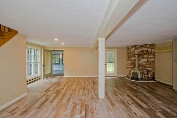 Empty room, Fireplace, Interior, Recessed Lighting, Stone Walls, Wood Texture Flooring