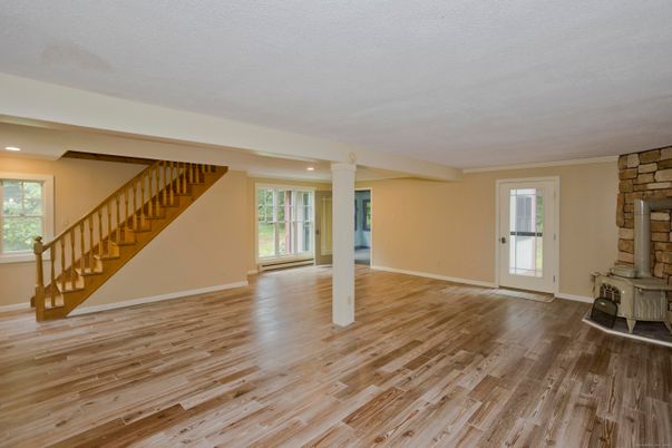 Empty room, Fireplace, Interior, Recessed Lighting, Stone Walls, Wood Texture Flooring