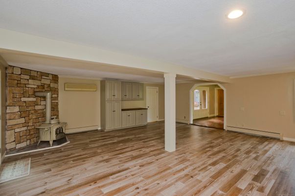 Empty room, Fireplace, Interior, Recessed Lighting, Stone Walls, Wood Texture Flooring