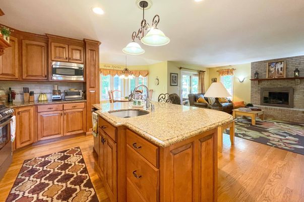 Fireplace, Interior, Kitchen, Pendant Lights, Recessed Lighting, Stainless Steel Appliances, Stone Walls, Wood Texture Flooring