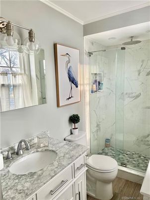 Bathroom, Dual Sink Vanities, Glass Shower, Interior, Marble Walls, Wood Texture Flooring