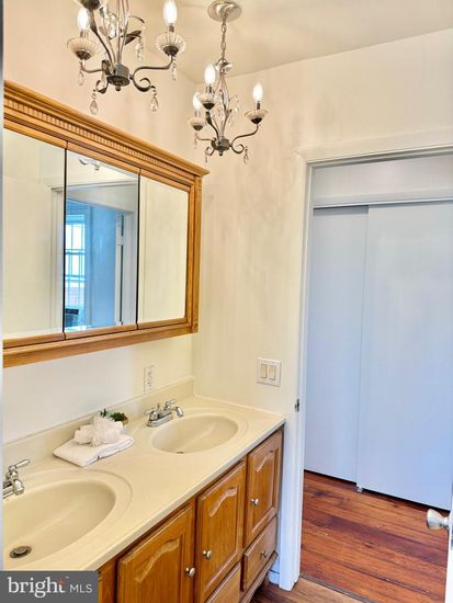 Bathroom, Chandelier, Dual Sink Vanities, Interior, Wood Texture Flooring
