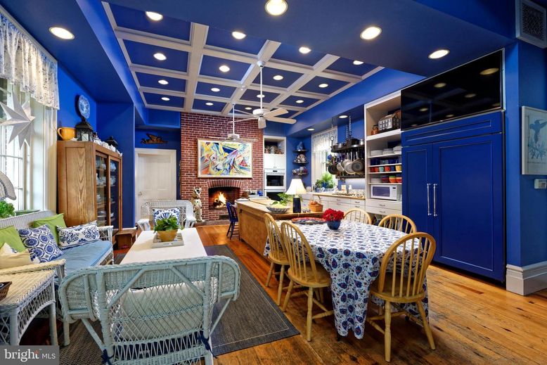 Dining room, Fireplace, Interior, Living room, Recessed Lighting, Stone Walls, Wood Texture Flooring
