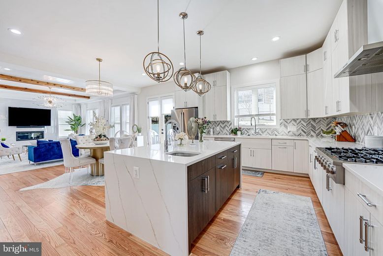 Chandelier, Dining room, Fireplace, Interior, Kitchen, Living room, Pendant Lights, Recessed Lighting, Stainless Steel Appliances, Wood Texture Flooring