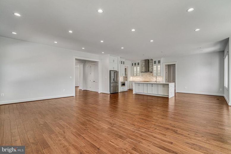 Empty room, Interior, Kitchen, Recessed Lighting, Stainless Steel Appliances, Wood Texture Flooring