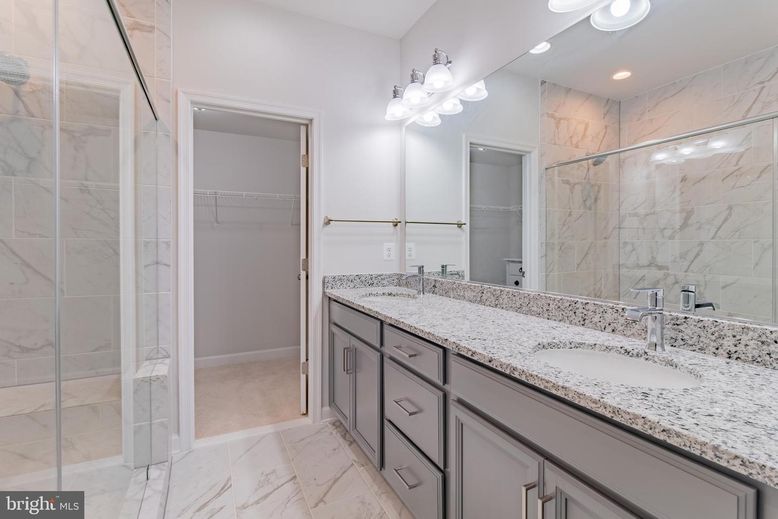 Bathroom, Dual Sink Vanities, Glass Shower, Interior, Marble, Marble Walls, Recessed Lighting, Walk-in Closets