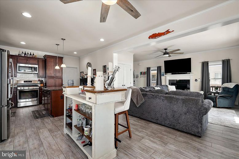 Fireplace, Interior, Kitchen, Living room, Pendant Lights, Recessed Lighting, Stainless Steel Appliances, Wood Texture Flooring