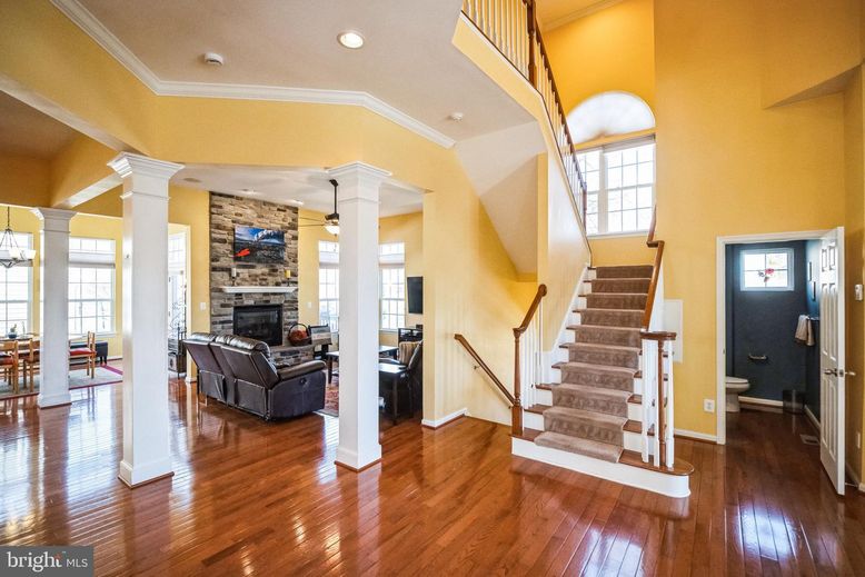 Dining room, Fireplace, Interior, Living room, Recessed Lighting, Stone Walls, Wood Texture Flooring