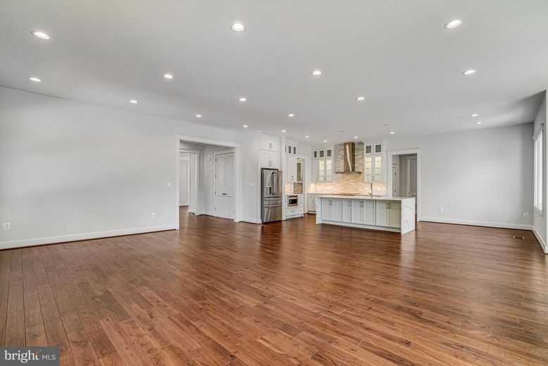 Empty room, Interior, Kitchen, Recessed Lighting, Stainless Steel Appliances, Wood Texture Flooring