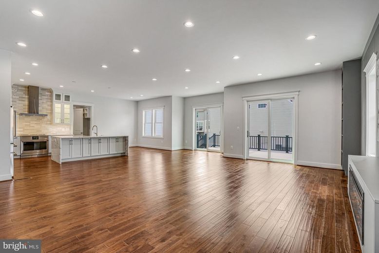 Empty room, Interior, Kitchen, Recessed Lighting, Stainless Steel Appliances, Wood Texture Flooring