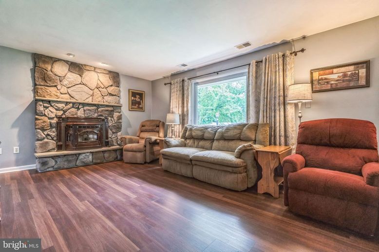 Fireplace, Interior, Living room, Recessed Lighting, Stone Walls, Wood Texture Flooring