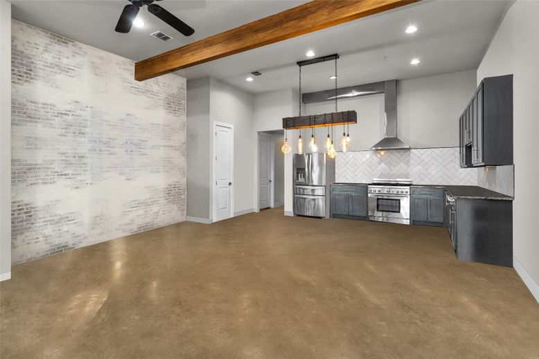 Empty room, Interior, Kitchen, Pendant Lights, Recessed Lighting, Stainless Steel Appliances, Stone Walls, Wooden Beams