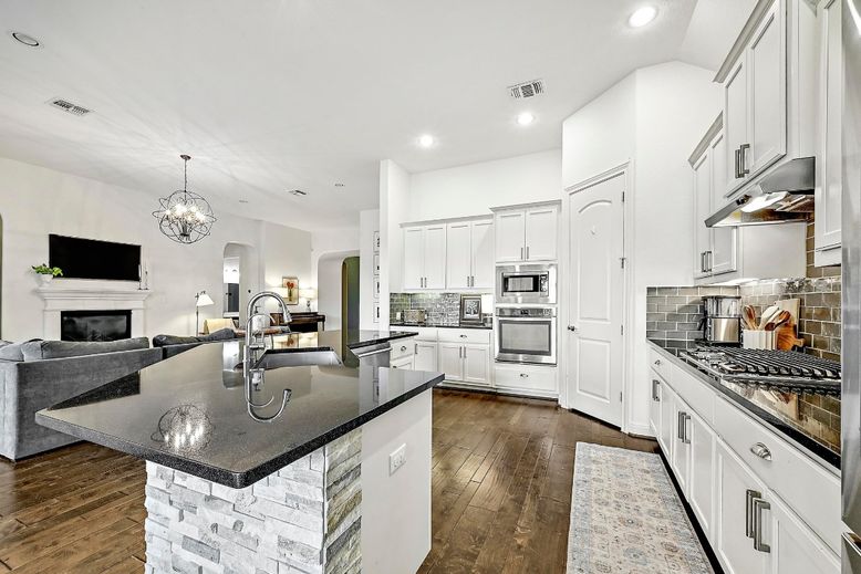 Chandelier, Fireplace, Interior, Kitchen, Pendant Lights, Recessed Lighting, Stainless Steel Appliances, Wood Texture Flooring