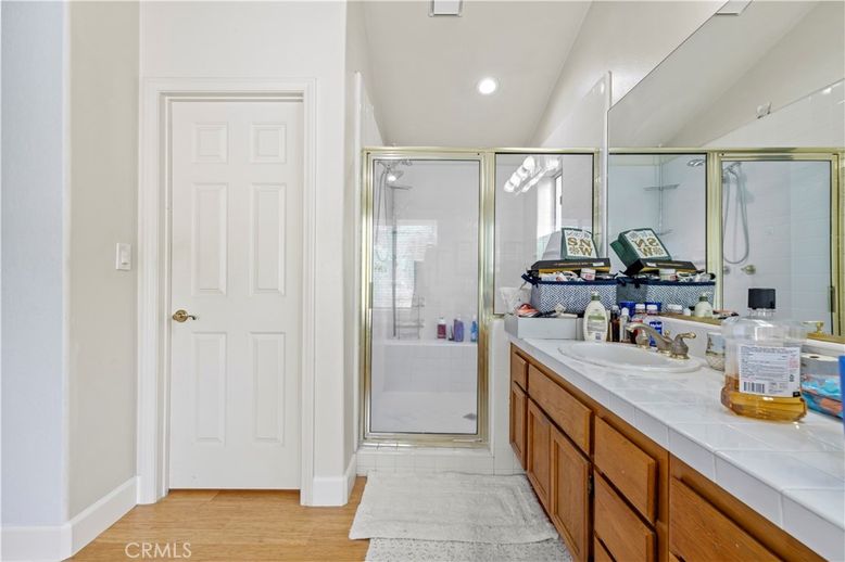Bathroom, Dual Sink Vanities, Glass Shower, Interior, Recessed Lighting, Tile Countertops, Wood Texture Flooring