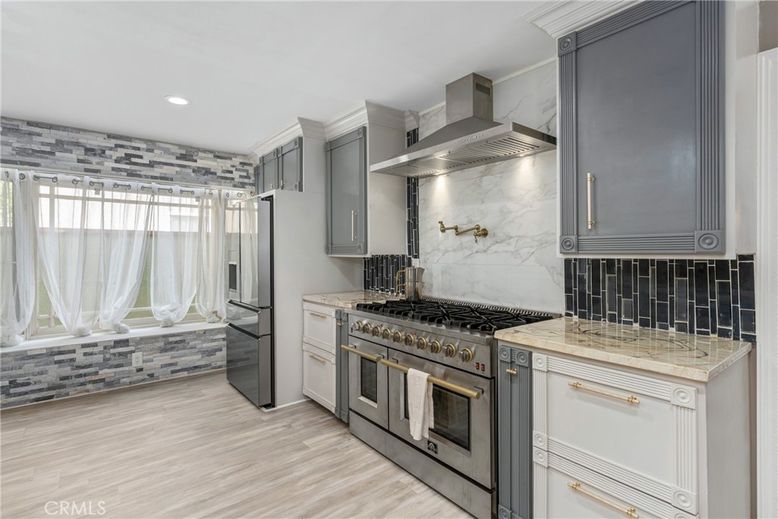 Interior, Kitchen, Marble Walls, Recessed Lighting, Stainless Steel Appliances, Wood Texture Flooring