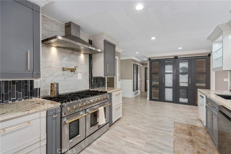 Interior, Kitchen, Marble Walls, Recessed Lighting, Stainless Steel Appliances, Wood Texture Flooring