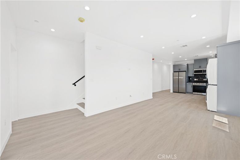 Empty room, Interior, Kitchen, Recessed Lighting, Stainless Steel Appliances, Wood Texture Flooring
