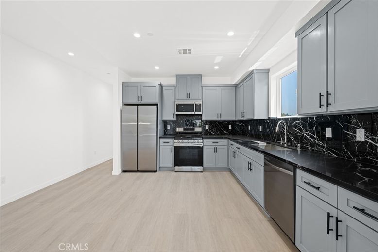 Interior, Kitchen, Marble Walls, Recessed Lighting, Stainless Steel Appliances, Wood Texture Flooring
