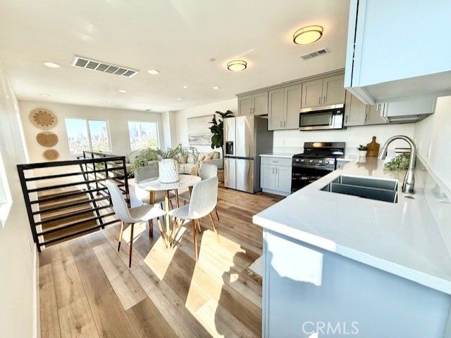 Dining room, Interior, Kitchen, Recessed Lighting, Stainless Steel Appliances, Wood Texture Flooring