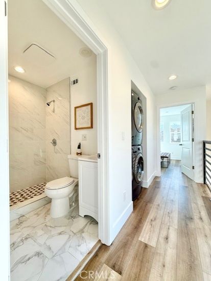 Bathroom, Glass Shower, Interior, Marble, Marble Walls, Recessed Lighting, Washer, Wood Texture Flooring