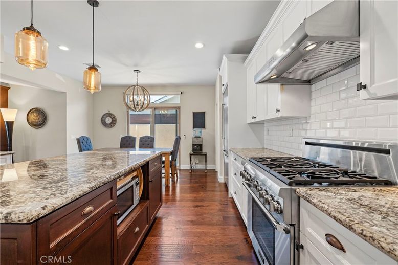 Chandelier, Dining room, Interior, Kitchen, Pendant Lights, Recessed Lighting, Stainless Steel Appliances, Wood Texture Flooring