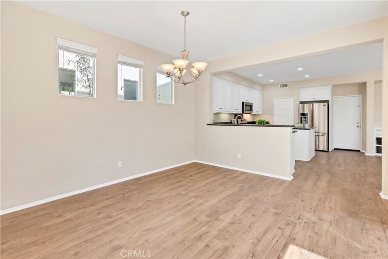 Chandelier, Empty room, Interior, Kitchen, Recessed Lighting, Stainless Steel Appliances, Wood Texture Flooring