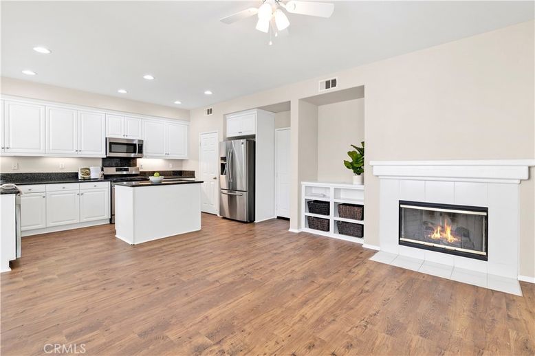 Fireplace, Interior, Kitchen, Recessed Lighting, Stainless Steel Appliances, Wood Texture Flooring