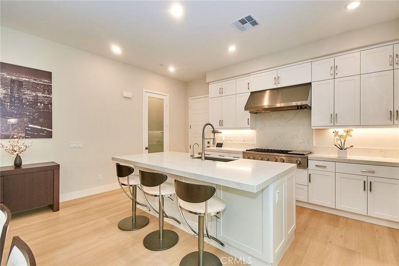 Interior, Kitchen, Marble Walls, Recessed Lighting, Stainless Steel Appliances, Wood Texture Flooring