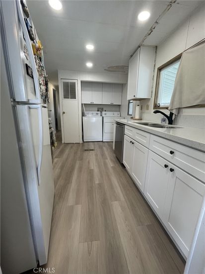 Interior, Kitchen, Recessed Lighting, Washer, Wood Texture Flooring