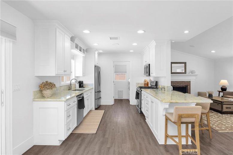 Fireplace, Interior, Kitchen, Recessed Lighting, Stainless Steel Appliances, Wood Texture Flooring