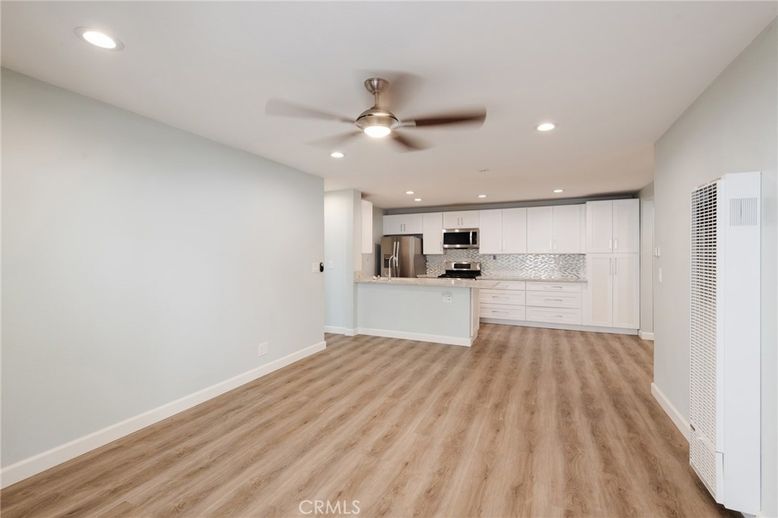 Empty room, Interior, Kitchen, Recessed Lighting, Stainless Steel Appliances, Wood Texture Flooring