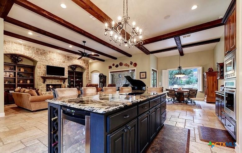 Chandelier, Dining room, Fireplace, Interior, Kitchen, Living room, Pendant Lights, Piano, Recessed Lighting, Stone Walls, Wooden Beams
