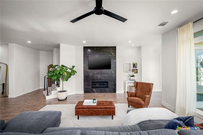 Fireplace, Interior, Living room, Marble Walls, Recessed Lighting, Wood Texture Flooring