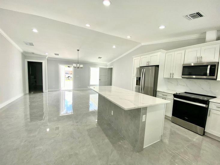 Interior, Kitchen, Marble Walls, Pendant Lights, Recessed Lighting, Stainless Steel Appliances